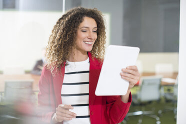 Smiling businesswoman with tablet in office - ZEF14000