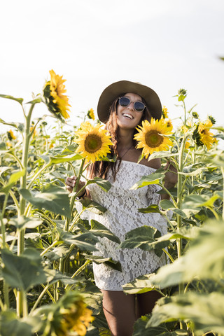 Happy woman in a sunflower field stock photo