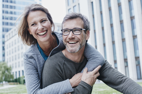 Happy mature couple hugging outdoors stock photo