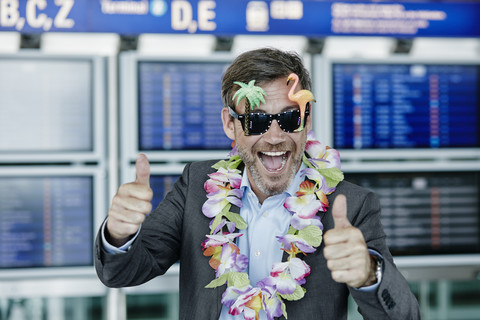 Happy businessman dressed up as tourist at the airport stock photo