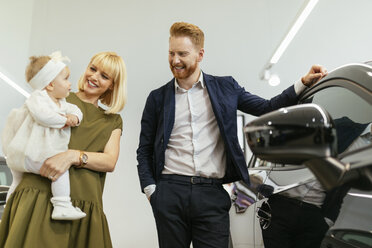 Family in car dealership choosing family vehicle - ZEDF00665