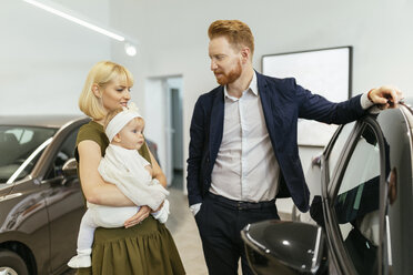 Family in car dealership choosing family vehicle - ZEDF00666