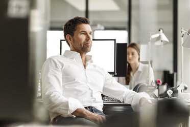 Businessman at desk in office - PESF00697