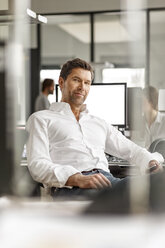 Portrait of businessman at desk in office - PESF00698