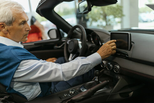Älterer Mann testet Cabrio im Autohaus - ZEDF00722