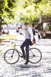 Älterer Geschäftsmann auf dem Fahrrad in der Stadt - HAPF01778