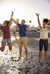 Happy friends jumping in the air on the beach - PACF00019