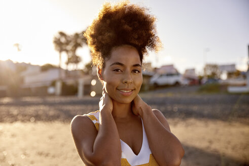 Portrait of smiling woman relaxing on the beach - PACF00022