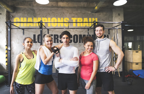Portrait of confident young people in gym stock photo