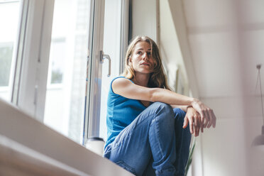 Young woman sitting at the window - KNSF01638