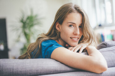 Portrait of young woman relaxing at home - KNSF01645