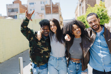 Happy stylish friends walking on urban street - GIOF02819