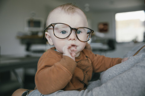 Baby boy wearing oversized glasses stock photo