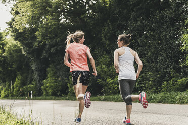 Two Women Running In Park Stock Photo, Picture and Royalty Free