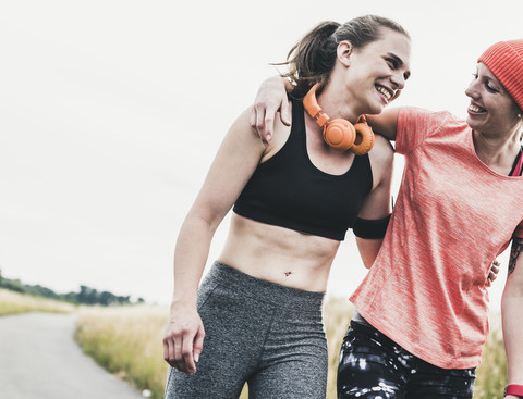 Two happy women having a break from exercising stock photo