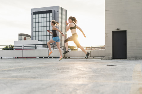 Two women exercising on parking level in the city stock photo
