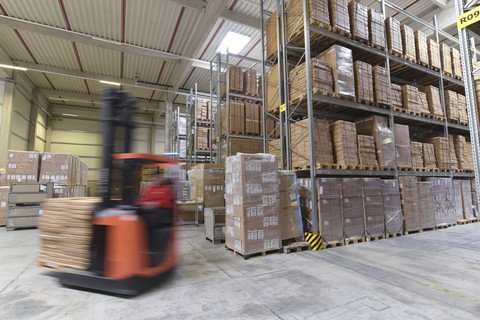 Moving forklift in factory hall stock photo