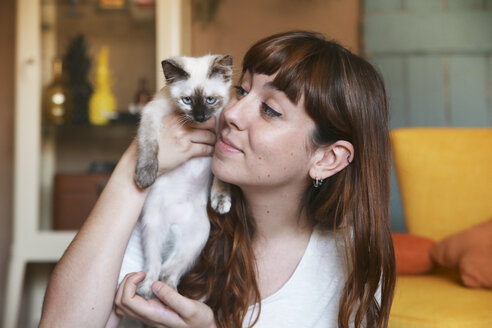 Young woman with kitten at home - RTBF00976