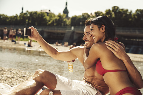 Verliebtes Pärchen macht Selfie am Strand, lizenzfreies Stockfoto