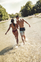 Back view of couple on the beach - SUF00167