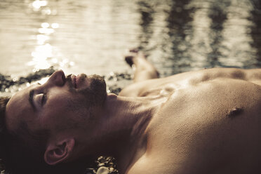 Man relaxing on the beach at sunset - SUF00171