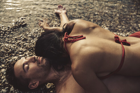Verliebtes Paar entspannt sich gemeinsam am Strand - SUF00172