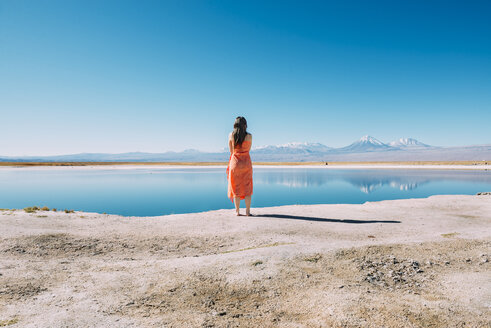 Chile, Atacama Desert, back view of woman standing on edge of Laguna Cejar - GEMF01720