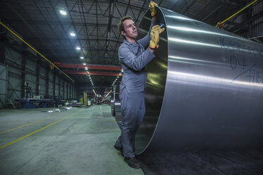 Arbeiter, der in einer Fabrik Metall beschriftet - ZEF14051