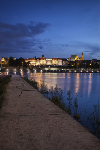 Poland, Warsaw, Old Town skyline with Royal Castle at night, view from pier on Vistula River stock photo