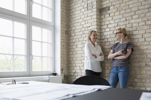 Mature businesswoman working with younger colleague in office stock photo