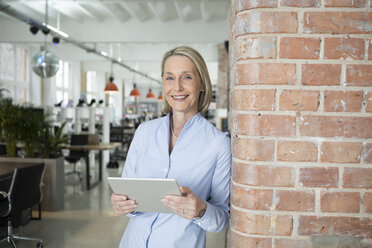 Mature businesswoman using digital tablet - RBF05775