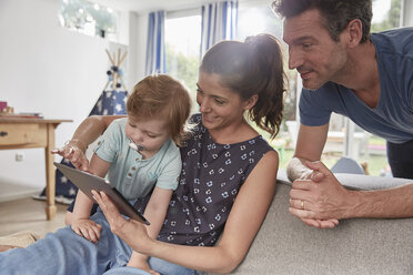 Happy family using tablet at home - SUF00229