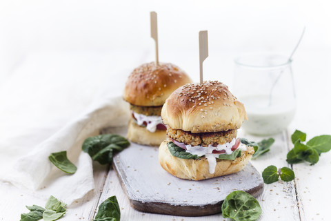 Vegetarian Burger with Halloumi Zucchini Carrot Patty, Tzatziki sauce, homemade bun stock photo