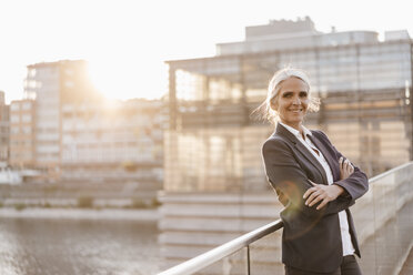 Portrait of confident businesswoman standing on bridge - KNSF01787