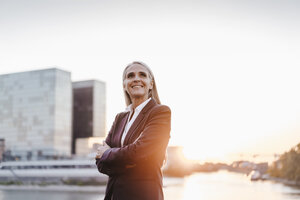 Confident businesswoman outdoors at sunset - KNSF01845