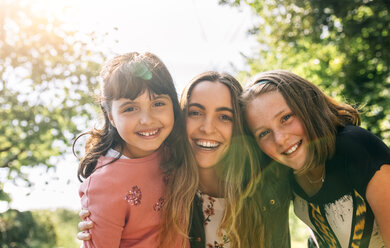 Portrait of three happy girls outdoors - MGOF03430