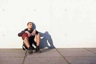 Young man with basketball having a break - FKF02442