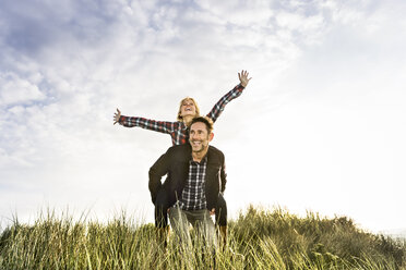 Happy playful couple in dunes - FMKF04254