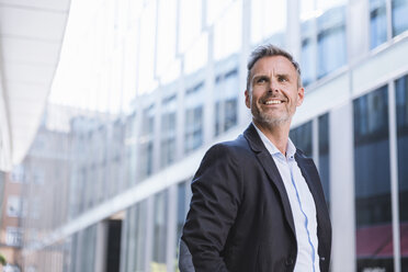 Portrait of smiling businessman in the city - DIGF02593