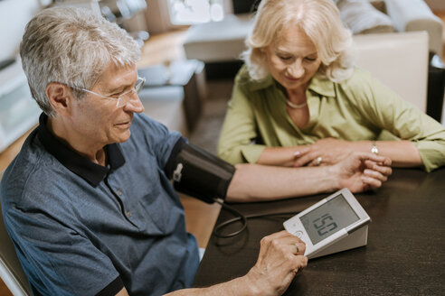 Senior couple taking blood pressure - ZEDF00762