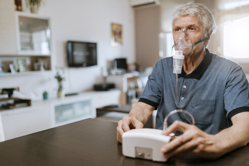 Senior man using inhaler at home - ZEDF00765