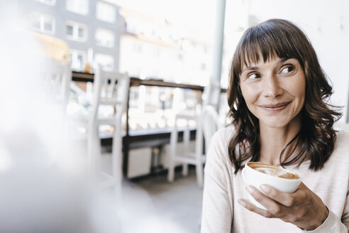 Woman in cafe, drinking coffee - KNSF01922