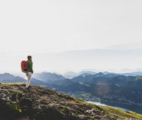 Hiker with backpack hiking in the Alps - UUF10977