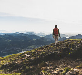 Hiker with backpack hiking in the Alps - UUF10982