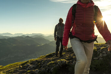 Couple hiking in the mountains at sunset - UUF11012