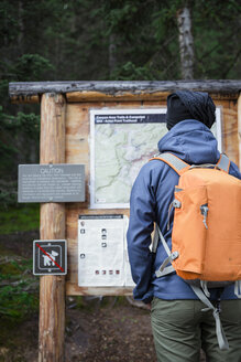 USA, Wyoming, Yellowstone National Park, Mann vor einer Informationstafel stehend - EPF00450