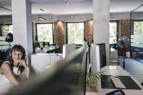 Geschäftsfrau, die im Büro arbeitet und telefoniert, lizenzfreies Stockfoto