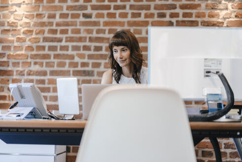 Businesswoman working in office - KNSF02061