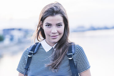 Portrait of smiling young woman with long brown hair - UUF11051