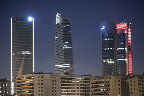 Spanien, Madrid, beleuchtete Wolkenkratzer im Finanzviertel bei Nacht, lizenzfreies Stockfoto